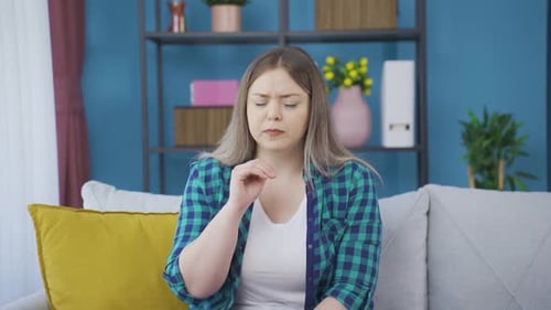 The sick young woman can't stop coughing.