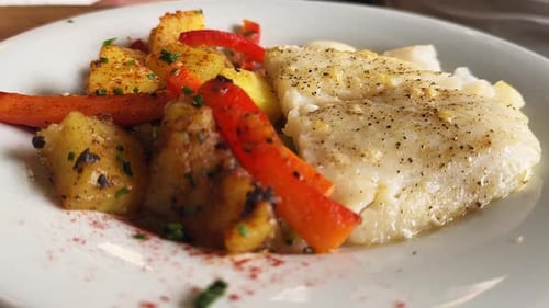 Fried White Fish Garnished with Grilled Vegetables on a Plate Sea Bass Fillet with Sauce Restaurant