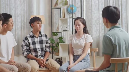 Young Adults Talking in Circle at Home