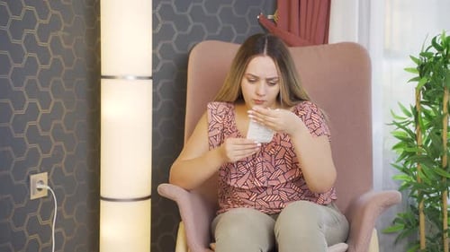 Woman Reading Medical Product Insert at Home