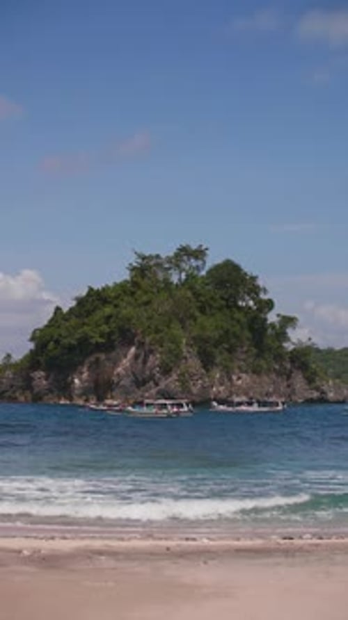 Boats on the Backdrop of a Tropical Island in the Ocean in Indonesia