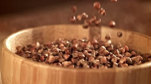 Buckwheat Falls Into a Wooden Bowl Filmed on a Highspeed Camera at 1000 Fps