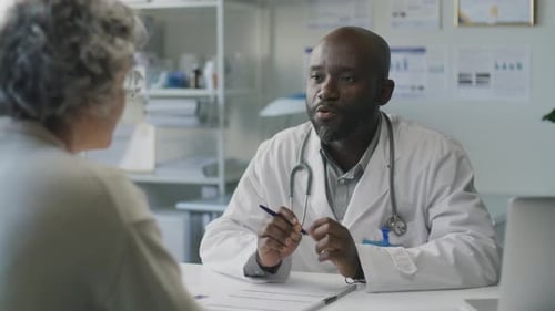 Doctor Consulting Patient in Bright Office Setting
