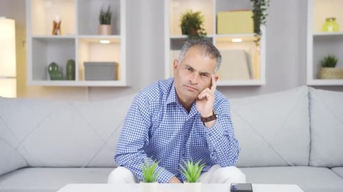 Man looking thoughtfully at camera.