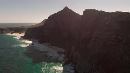 Slowly Flying Upwards Next to the Mountains at Cape Point, South Africa During Sunset
