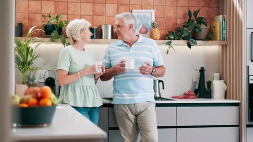 Senior Couple Enjoying Coffee Together in Kitchen