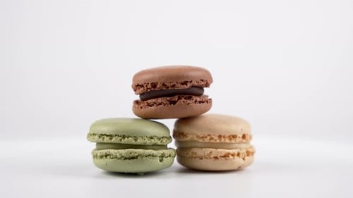Delicious colorful macarons on a white surface