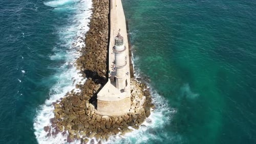 Aerial drone video of iconic Venetian lighthouse in the entrance of picturesque old port of Chania w