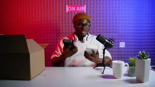 Content Creator Unboxing Electronic Device in Studio