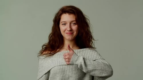 Smiling Woman Gives Thumbs Up Close Up