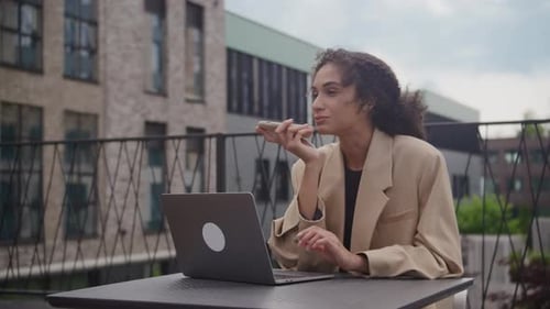 Young Adult Woman Working on Laptop Outdoors