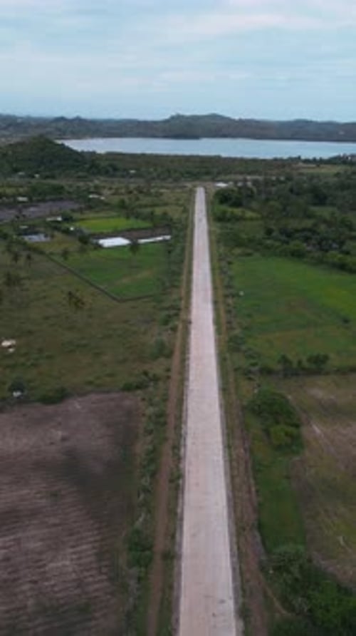 Highangle Shot Capturing Vehicle Movement On Vibrant Coast Road