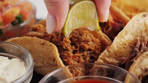 Close Up Tacos Being Squeezed with Lime