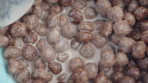 Chocolate Cereal Balls with Milk on a Spoon