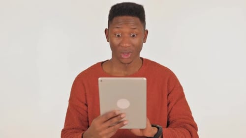 Man Celebrates Good News on Tablet