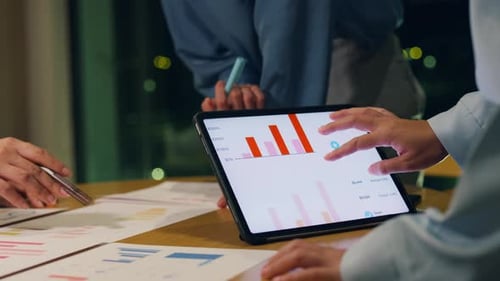 Asia businesspeople meeting plan analysis statistics brainstorm at office night.