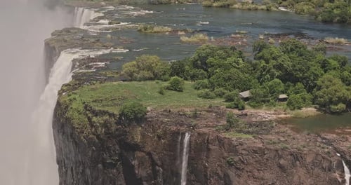 Victoria Falls Zimbabwe Aerial v10 zoomed birds eye view capturing waterfall plunging into a gorge,