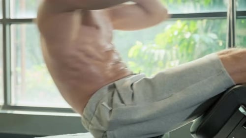 Fit Man Doing Sit Ups in Gym