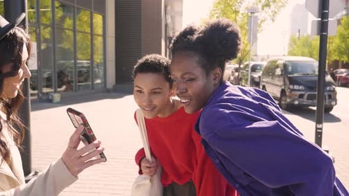 Women Friends Using Smart Phone On Sunny City Sidewalk Slow Motion