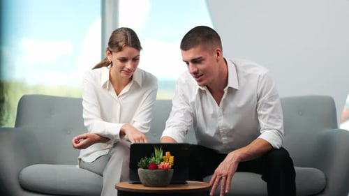 Team Discussing Tablet in Bright Workplace Setting