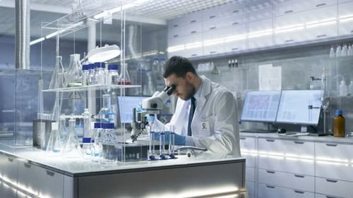 Scientist Works with Microscope in Modern Laboratory