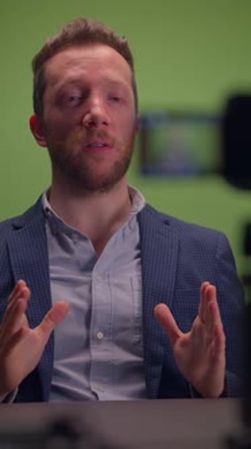 A Professional Speaker Works in Front of the Camera on a Green Screen Production Setup