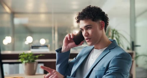 Young man talking on the phone in office