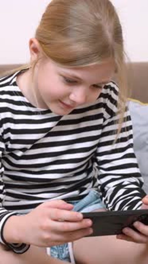 Girl with Fair Hair Using a Mobile Phone