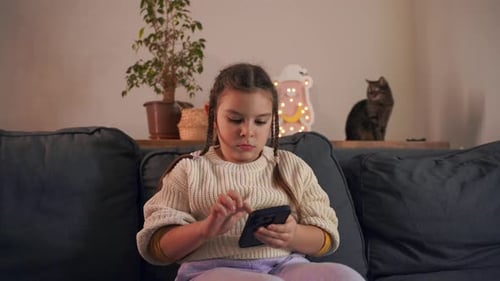 Child Using Smartphone in a Cozy Home Setting