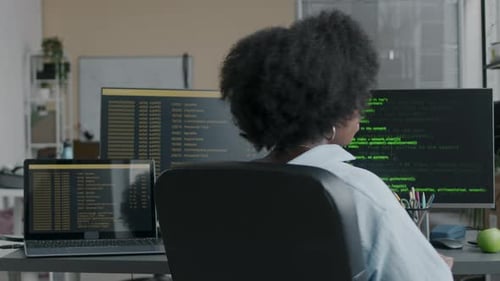 Portrait of Black Female Programmer Coding on Computer in Office