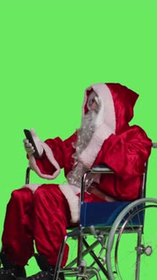 Vertical Video Side View of Santa Texting and Being on Videocall