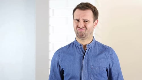 Man Making a Disgusted Face Indoors