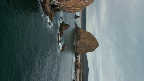 Vertical Wide Aerial Shot of Haystack Rock Beach in Coastal Town Cannon Beach Oregon