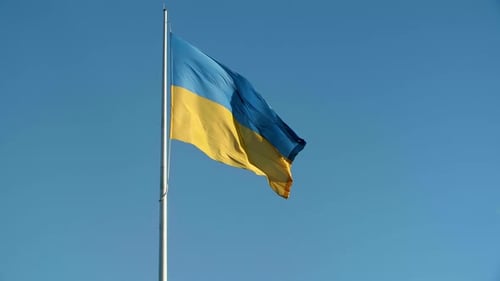 Ukrainian Flag Waving Against a Blue Sky