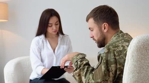 Man in Camo Jacket Talking to Therapist