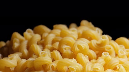 Rotating Pile of Yellow Cavatappi Pasta Noodles