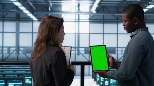 Developers in Data Center Using Mockup Tablet Observing Performance Analytics