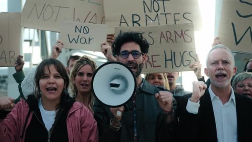 Diverse Group Protesting Against War With Megaphone