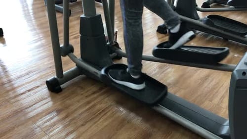 Close up foot working out on the stepper exercise machine at the gym, stepper machine on the wooden