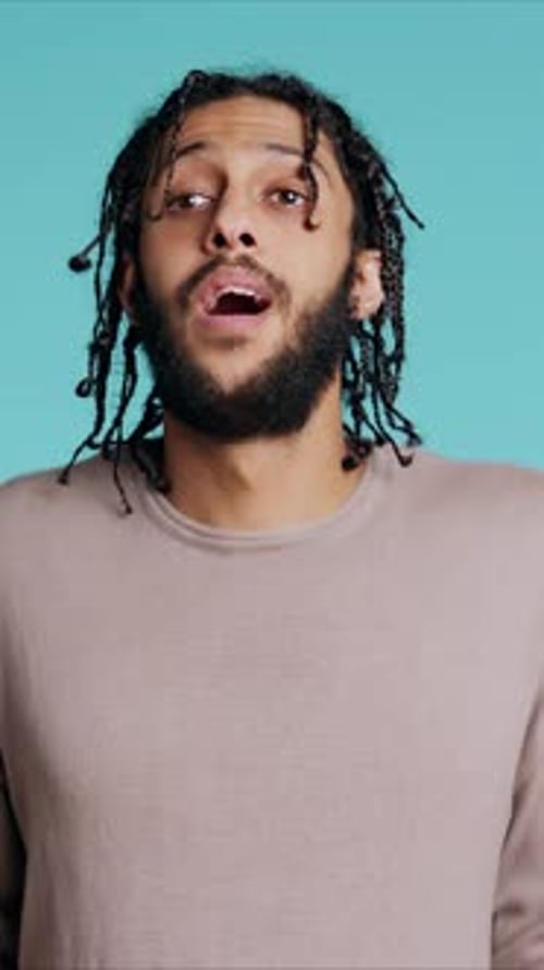 Vertical Video Uncaring Man Shrugging Shoulders Showing Indifference Studio Background