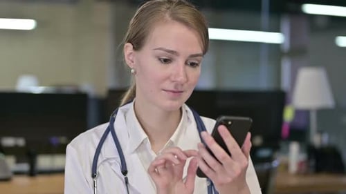 Female Doctor Using Smartphone in a Medical Office