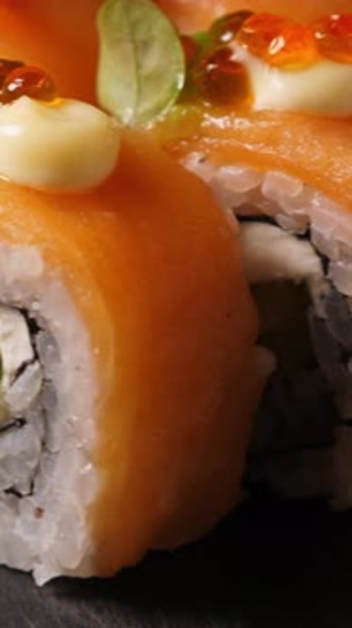 Delicious Salmon Sushi Roll Being Picked Up