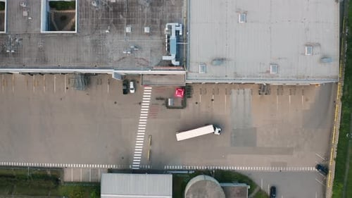 Truck Performs Maneuver Leaving Food Warehouse Ground