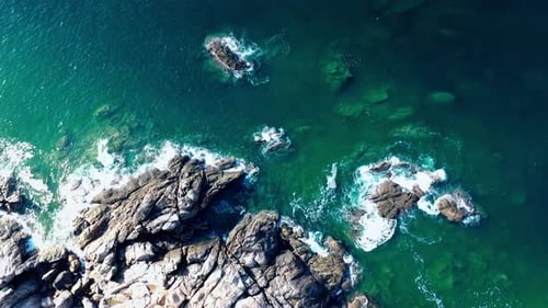 Aerial Top view of a transparent blue sea with beautiful waves at sunny day in summer. air of ocea