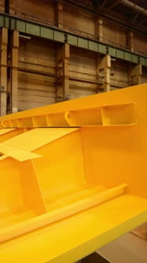 Large Yellow Metal Structure Rotating in Industrial Workshop Stock Clip