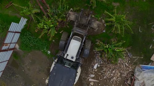 Aerial View of Tractor Moving Dirt on Farm