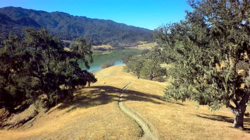 Aerial View Of Gorgeous Mountainside Lake On Sunny Day 4