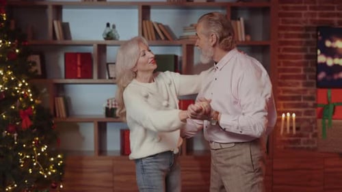 Senior Couple Joyfully Dancing at Christmas Time