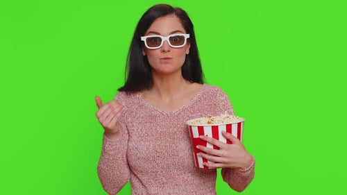Woman in 3D Glasses Eats Popcorn on Green Screen