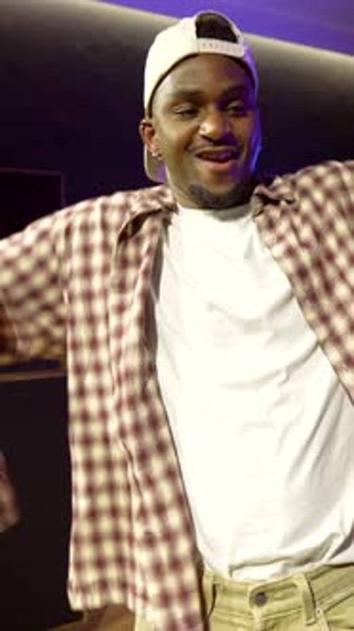 Young male dancer performing urban dance in recording studio